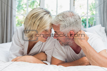 Portrait of a mature couple lying in bed