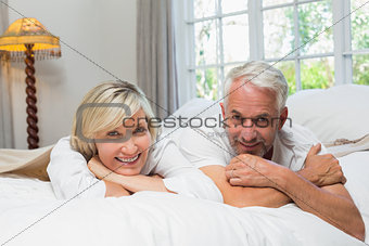 Portrait of a happy mature couple in bed