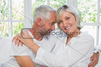 Loving happy mature couple with arm around