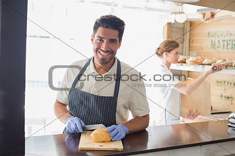 Smiling waiter at the coffee shop counter