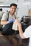 Waiter giving packed food to a woman at coffee shop