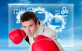 Composite image of confident businessman wearing boxing gloves