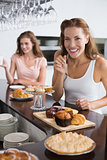 Smiling woman with sweet food at coffee shop