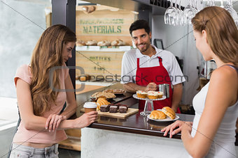 Women looking at sweet food at coffee shop