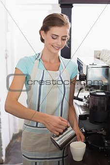Female barista preparing espresso at coffee shop