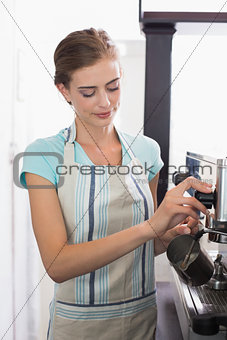 Female barista preparing espresso at coffee shop