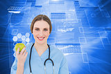 Composite image of young woman doctor holding a green apple