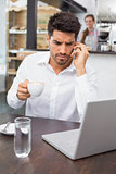 Man using mobile phone in coffee shop