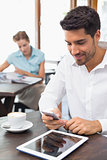 Man text messaging in coffee shop