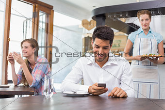 Smiling people sitting in coffee shop