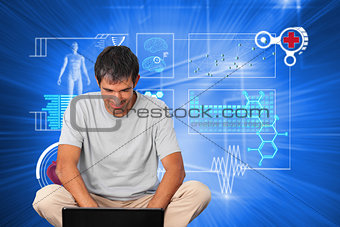 Composite image of bright man using a laptop