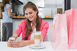 Woman using mobile phone in coffee shop