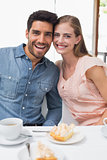 Portrait of a smiling couple at coffee shop