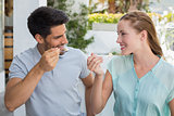 Cheerful young couple eating at coffee shop