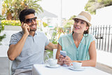 Couple with mobile phones at coffee shop
