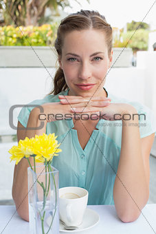 Portrait of a beautiful woman drinking at café