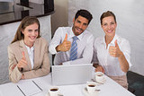 Business people gesturing thumbs up