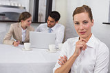Businesswoman with colleagues in meeting at office desk