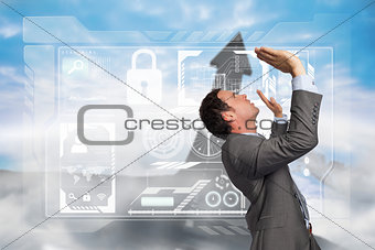 Composite image of businessman standing with arms pressing up