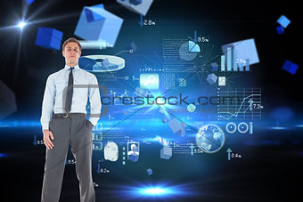 Composite image of serious businessman standing with hand in pocket