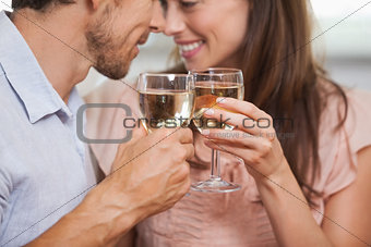 Close-up of a couple toasting wine glasses
