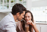 Loving young couple sharing a drink