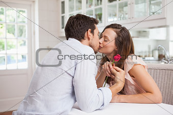Loving young couple kissing in kitchen