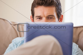 Man using digital tablet in living room