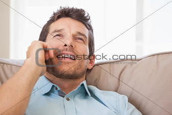 Man using mobile phone in living room