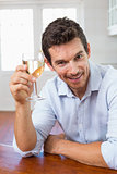 Smiling young man holding a wine glass