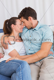 Relaxed couple looking at each other in living room