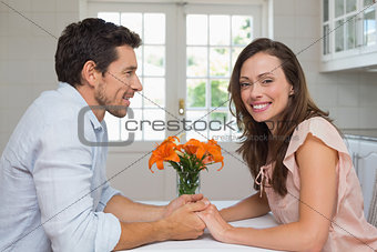 Portrait of a loving couple holding hands in kitchen