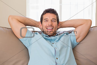 Portrait of happy relaxed man sitting on couch