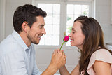 Side view of a loving couple with a rose