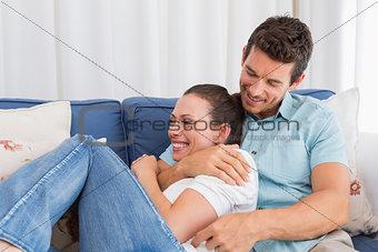 Portrait of a loving couple sitting on couch