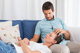 Relaxed woman resting on mans lap on couch