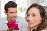 Happy woman and man with flowers at home