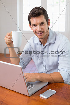 Portrait of a smiling man with coffee cup