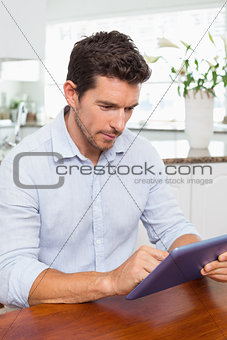 Concentrated man using digital tablet
