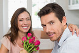 Close-up of a happy man and woman with flowers