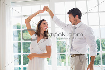 Loving couple dancing at home