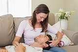 Man resting on womans lap on couch