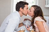 Loving young couple kissing at home
