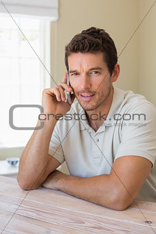 Smiling young man using mobile phone