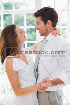 Loving young couple looking at each other at home