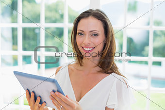 Beautiful woman with digital tablet at home
