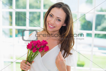 Beautiful woman with flowers at home