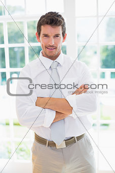 Smart businessman with hands folded at home