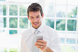 Businessman text messaging at home
