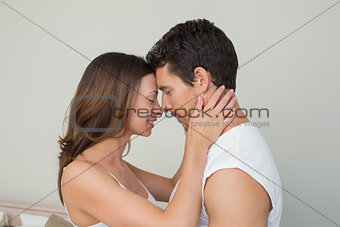 Side view of a loving couple with eyes closed
